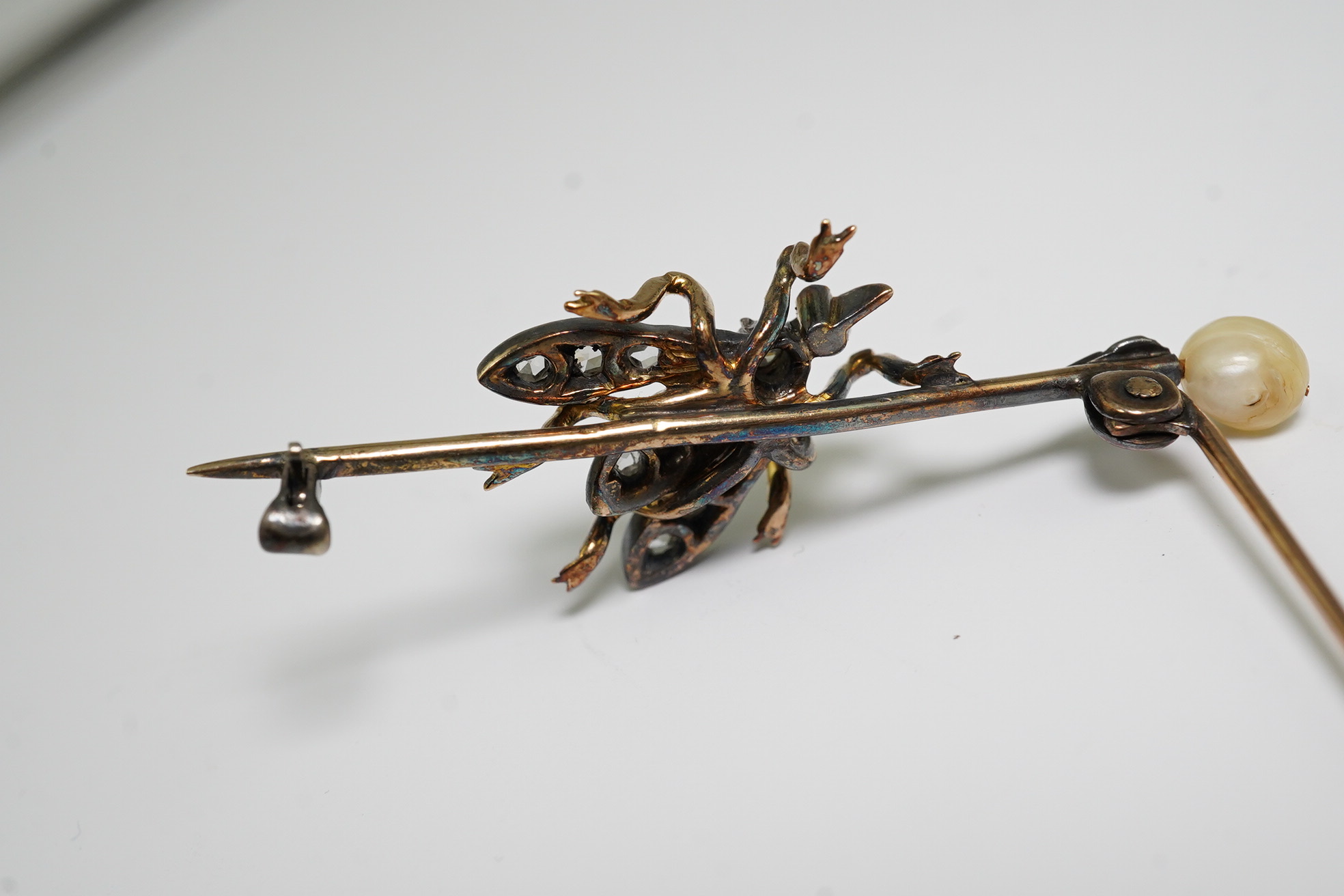 A Victorian gold and silver, pearl, rose and old cut diamond set 'bug' bar brooch